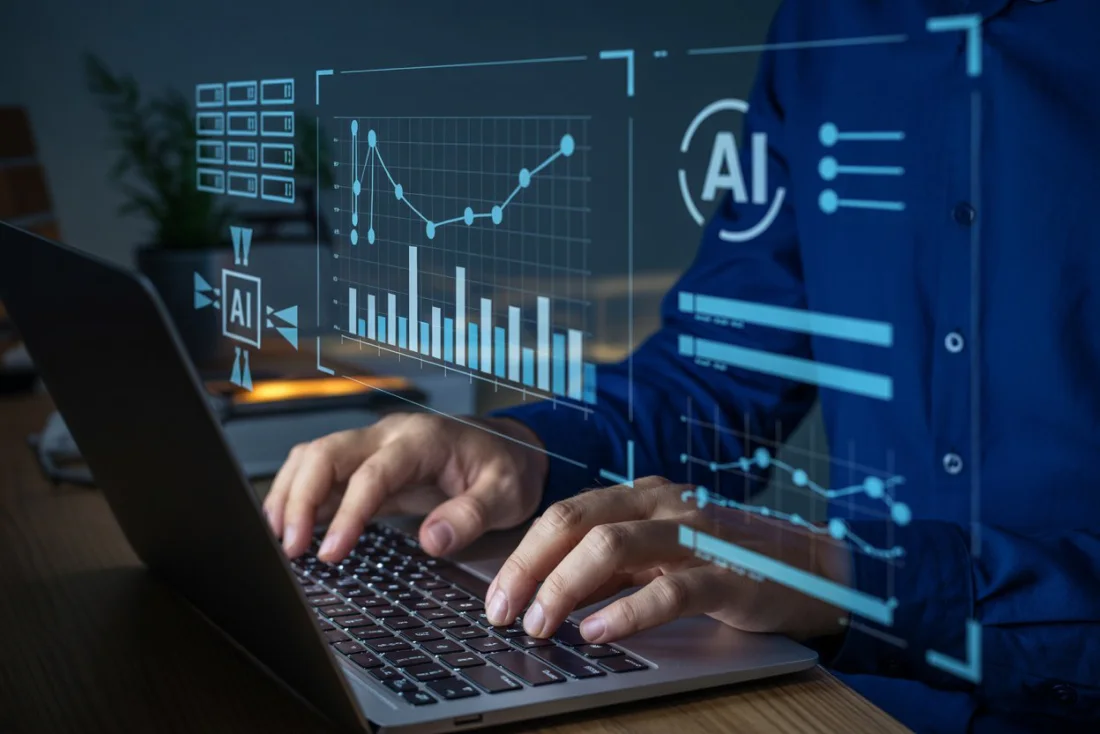 Analyst reading AI and cloud analytics on a laptop